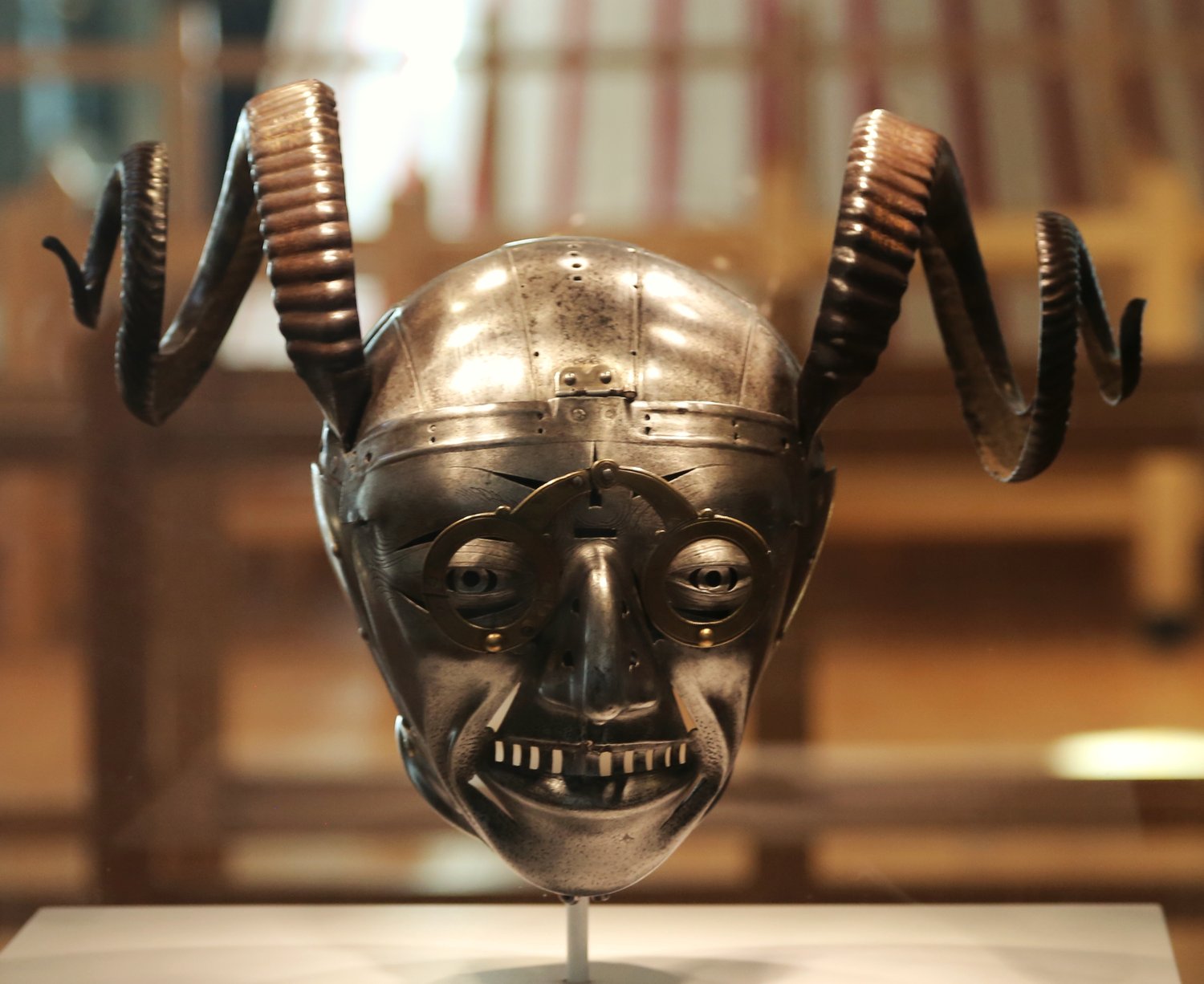 Henry VIII's horned helmet at the Royal Armouries, a steel face with spectacles, a grimace and curled ram's horns