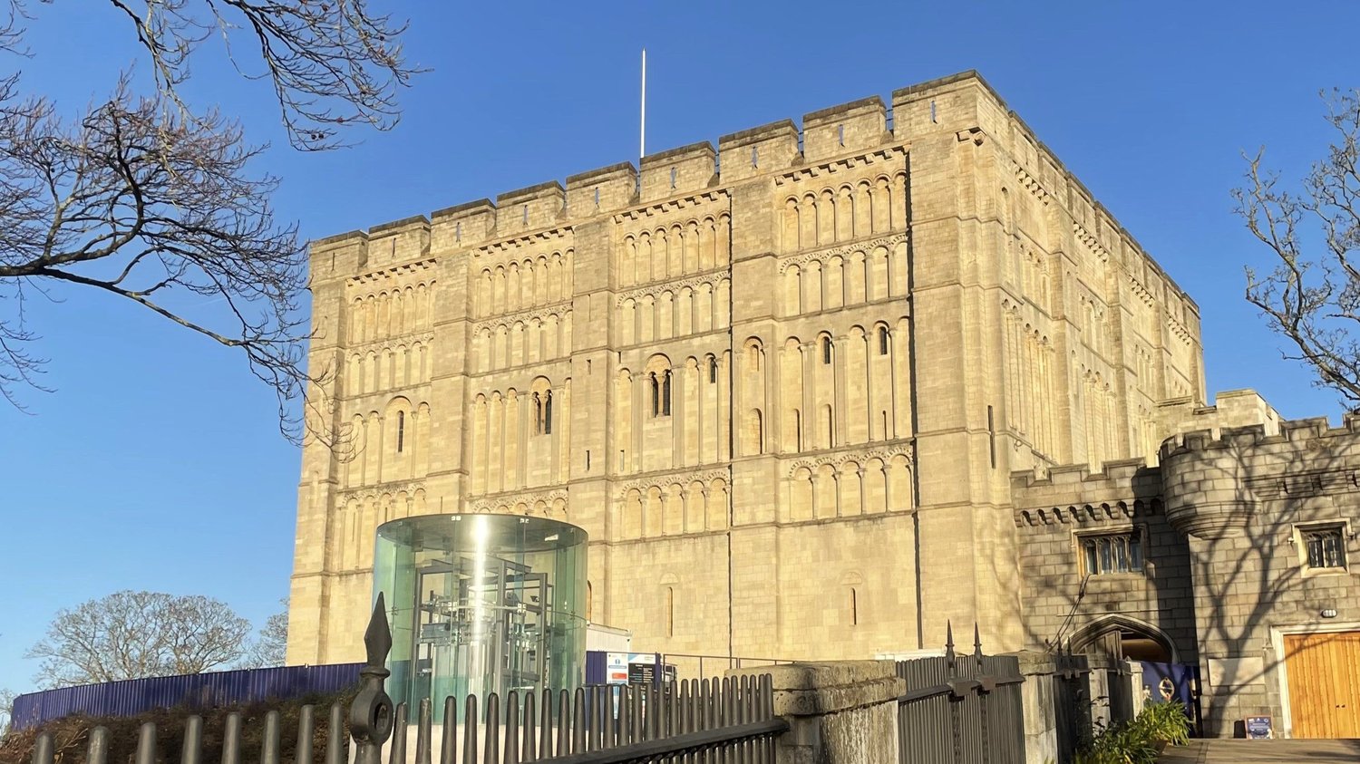 The Norman keep of Norwich Castle in low winter sun against a clear blue sky